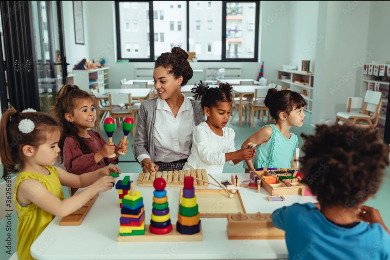 Teacher and children learning with a laptop